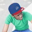 Load image into Gallery viewer, Person wearing Saltbox Brewing Comapny unisex flat bill hat in true royal and true red