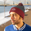 Load image into Gallery viewer, Man with grey and red Saltbox pom pom beanie on head