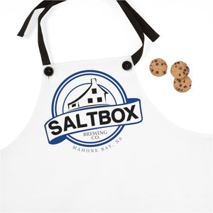 White apron with Saltbox logo laying next to 3 cookies